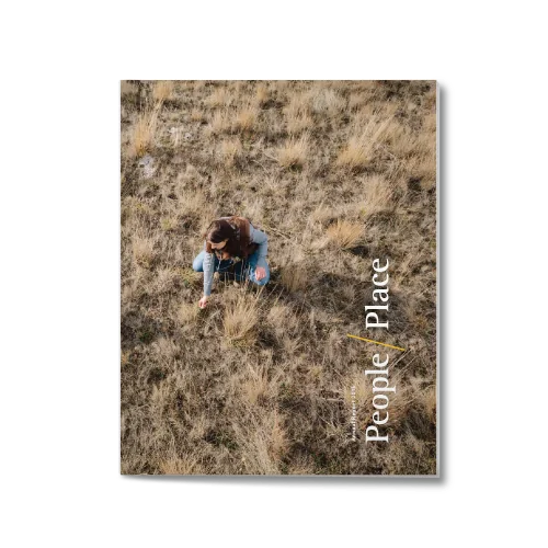 annual report cover image showing title "People and Place" and a woman crouching down to check the ranchland soil