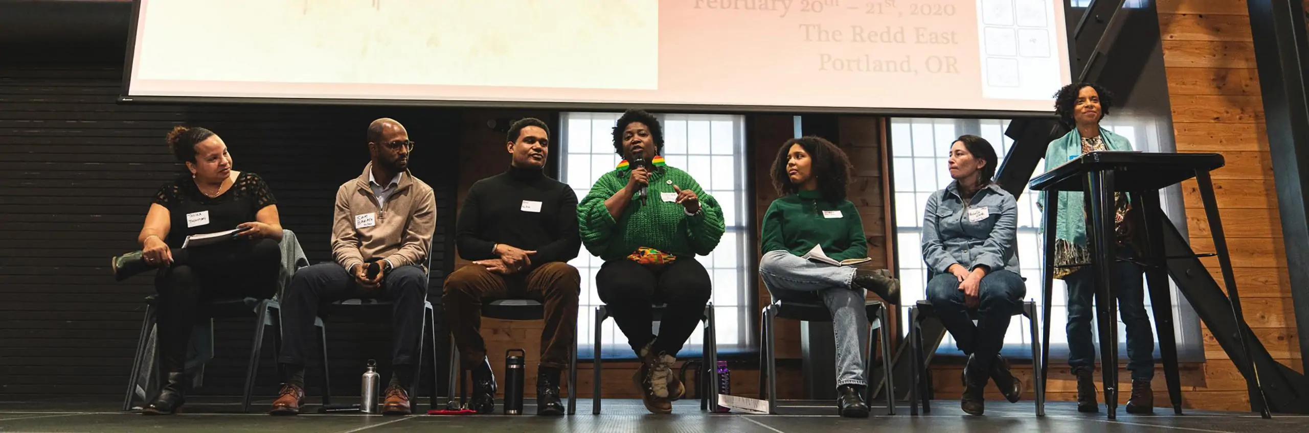 The Climate Justice panel, featuring Tanika Thompson of Got Green Seattle, Sam Baraso of the Portland Clean Energy Fund, Bill Beamer of the Portland Climate Action Team, Laquida Landford of Green In The Hood PDX, Janaira Ramirez of PAALF, and Michelle Week of Good Rain Farm, with one of the moderators, Jamese Kwele of Ecotrust. Photo by Noah Thomas