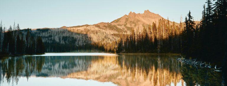 A photo of the peak of Seekseekqua (Mount Jefferson) reflected in Duffy Lake