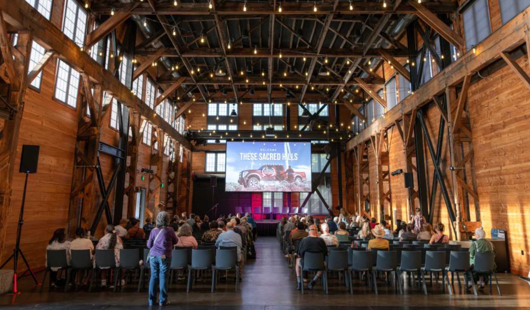 film screening in large hall, people seated