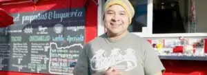 A photo of a person standing in front of a food truck