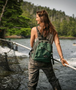 Woman dip net fishing in a river