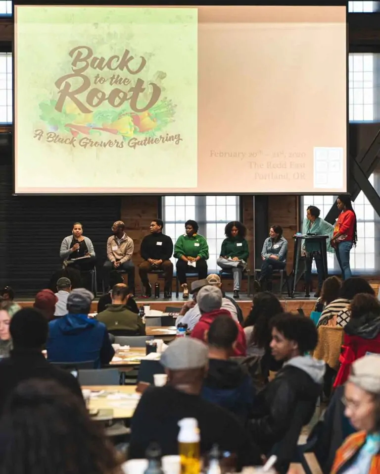 Event attendees gathered to watch several panelists on a stage