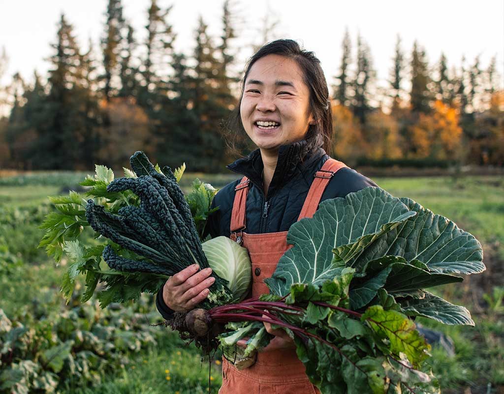 Person holding vegetables