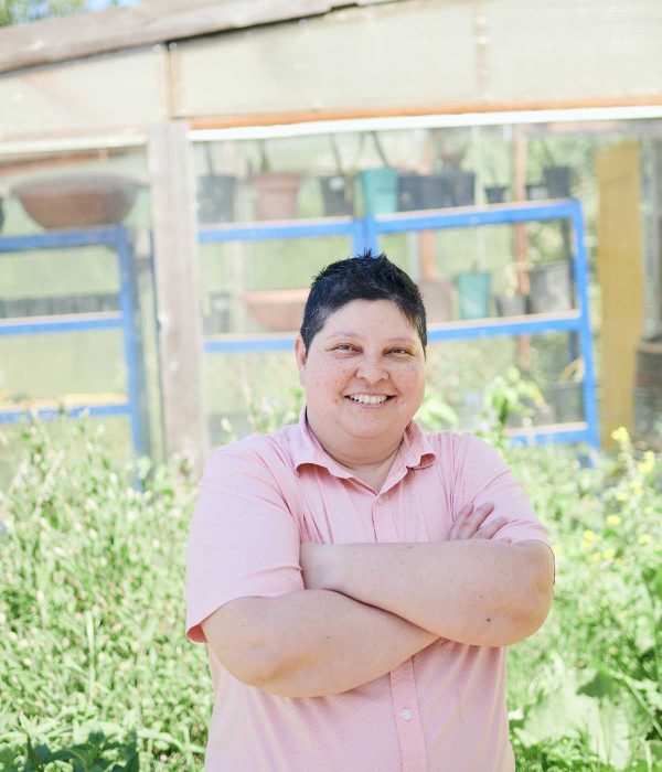 Person smiling at camera outside on a farm