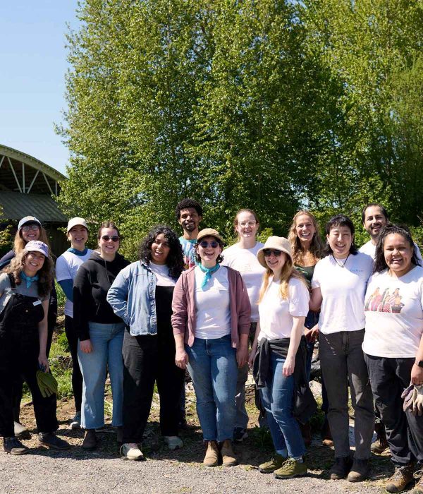group of people smiling on farm, sunshine spring
