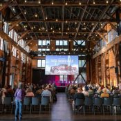 film screening in large hall, people seated