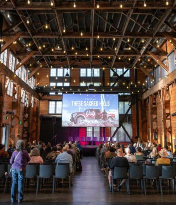 film screening in large hall, people seated