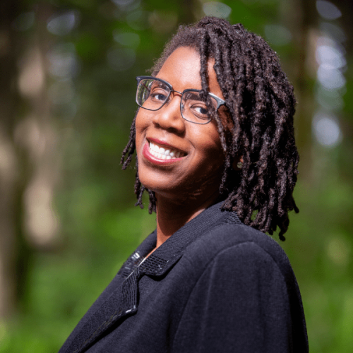 tanikka website side profile photo of smiling person with glasses