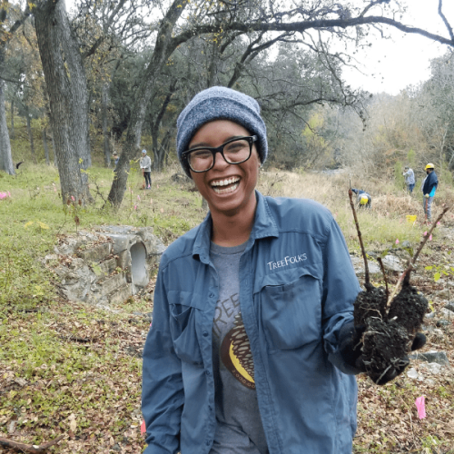 zoe website smiling person with beanie and blue long sleeve outside